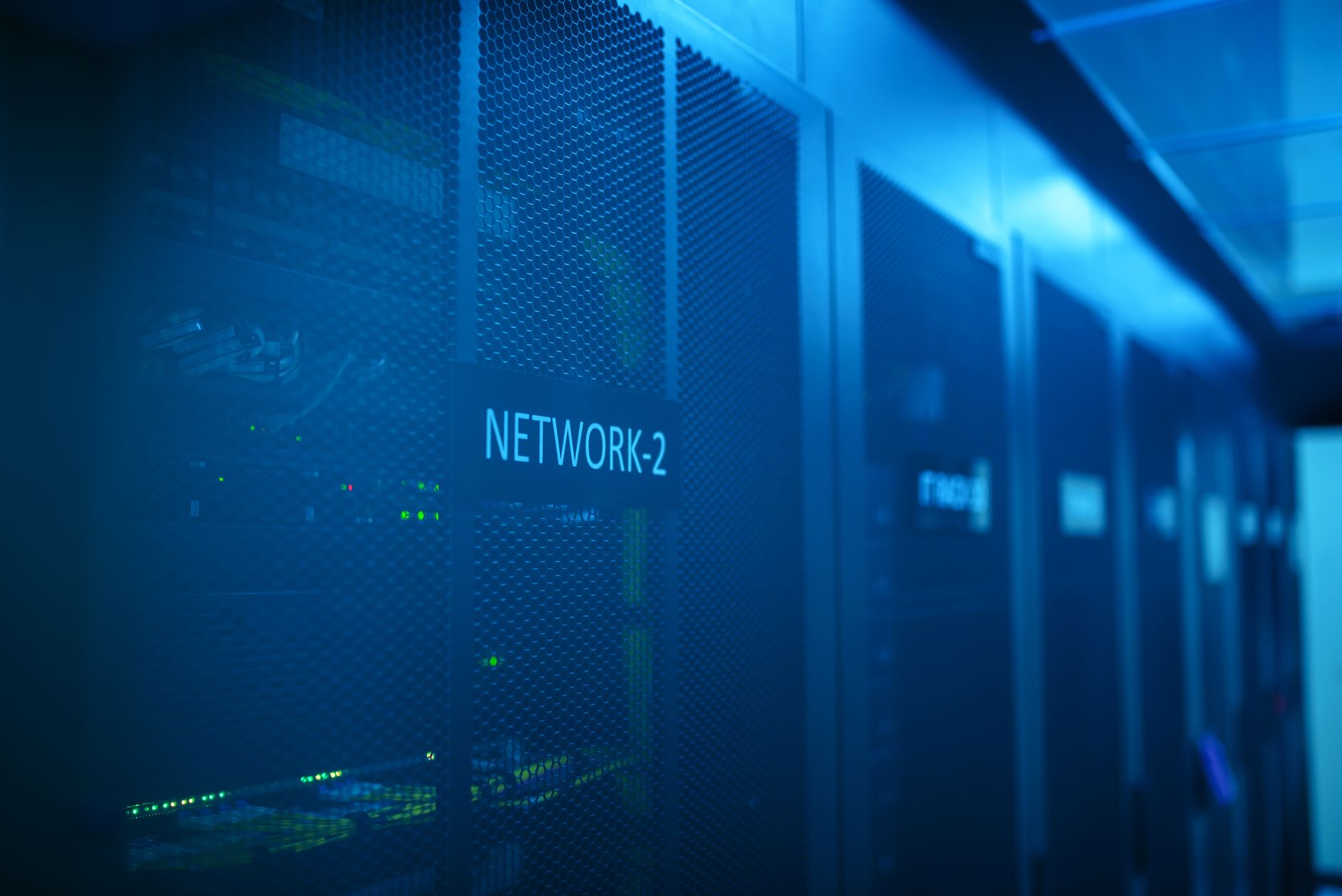 A modern server room featuring network equipment with blue illumination. Ideal for technology the... (Photo by panumas nikhomkhai on Pexels)